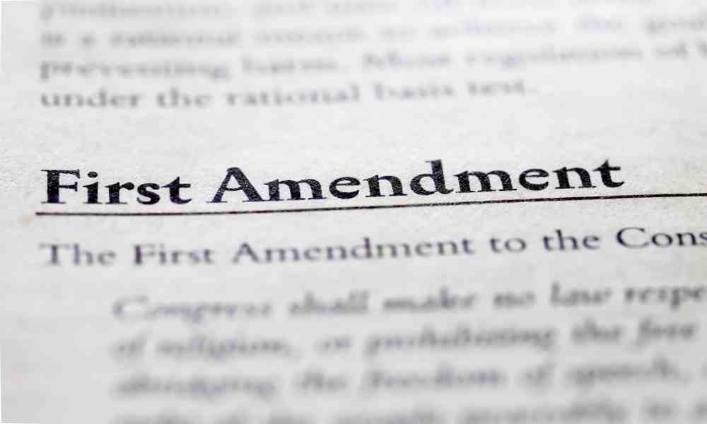A close-up picture of the words "First Amendment" and its blurred definition likely in a legal book.